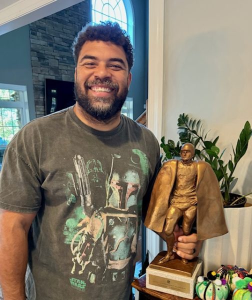 Cameron Heyward holding the NFL Walter Peyton Man of the Year Award.