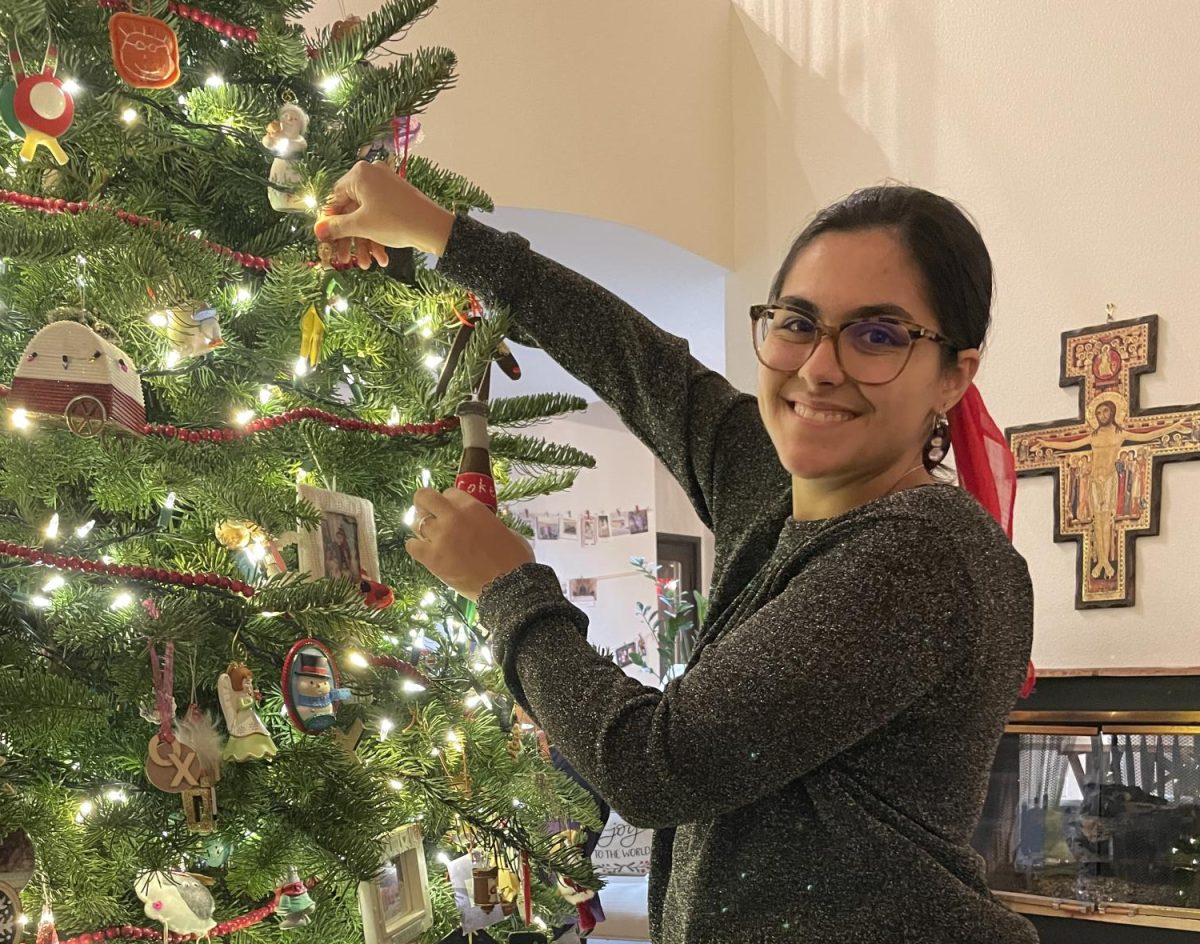 Magdelena decorating the family Christmas Tree on Christmas Eve!